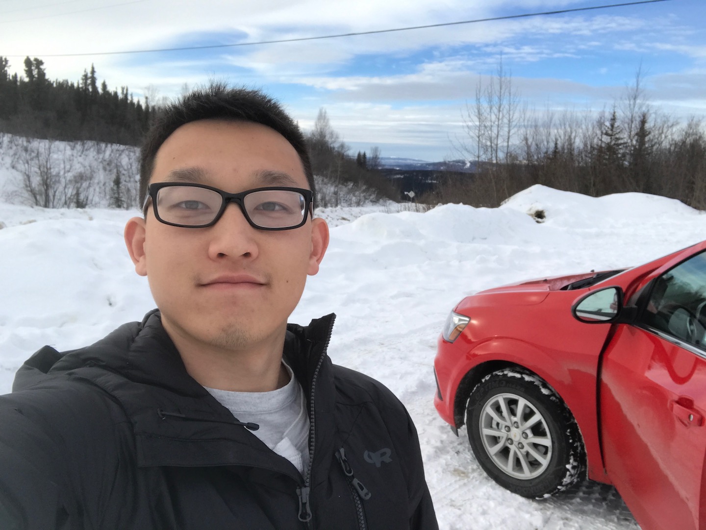 Me with my trusty red rental car, taking a selfie with some snow at Cleary Summit